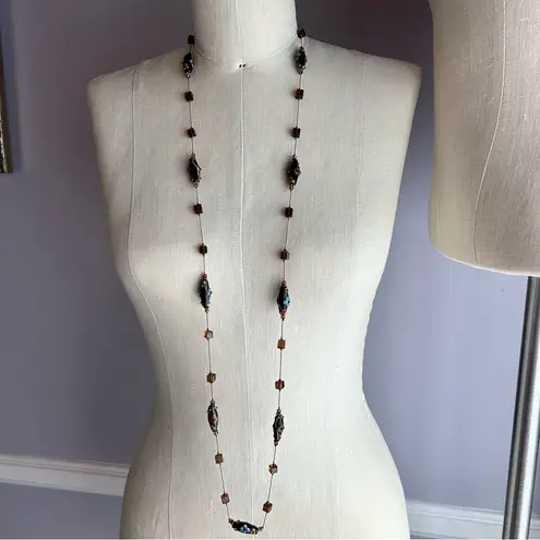 Brown and blue lampwork beads and square beads on a long chic necklace