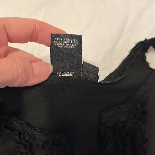 BCBGMAXAZRIA  size medium black sleeveless top ruffles around a V neck GUC