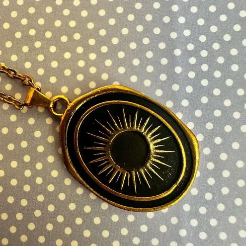 Like calls to Like gold tone and black starburst pendant necklace