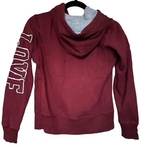 Reflex maroon zip up jacket with "love" on the sleeve Size M