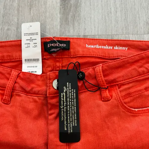 Bebe NWT  destroyed heartbreaker skinny jeans in orange