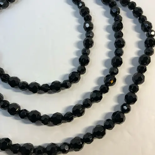 Vintage style 3 strand black beaded necklace with gold tone feather accent