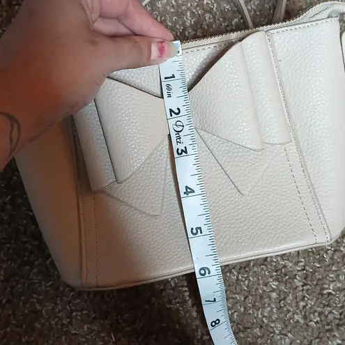 Grossi cream bow front pebble leather mini crossbody purse Gold