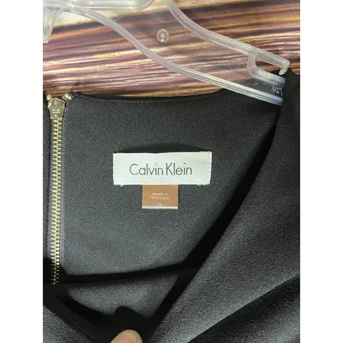 Calvin Klein Black Dress Size 2 Fitted with 3/4 Bell Sleeve With gold Rings.