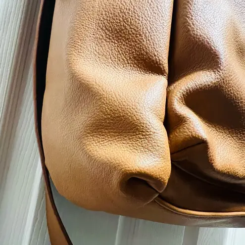 Brown patent leather diaper bag with multiple pockets and key holders