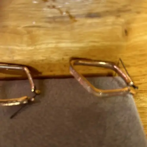 Very pretty pierced earrings. They’re sparkly pink. No callouts on the earrings.