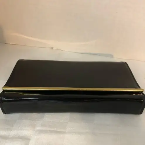 Vintage faux black patent leather clutch with gold trim.