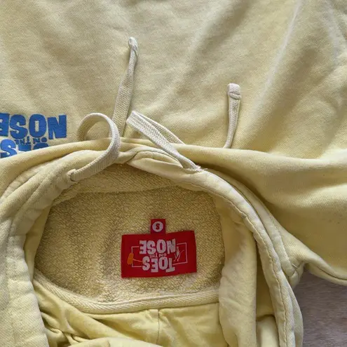 Toes on the nose Yellow Hoodie with Front Pocket and blue lettering