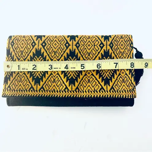 Tribal print and black small clutch black with tassel on the zipper snap closure