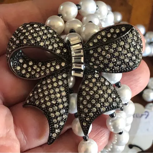 R.J. Graziano triple strand graduated white pearl stone bow necklace