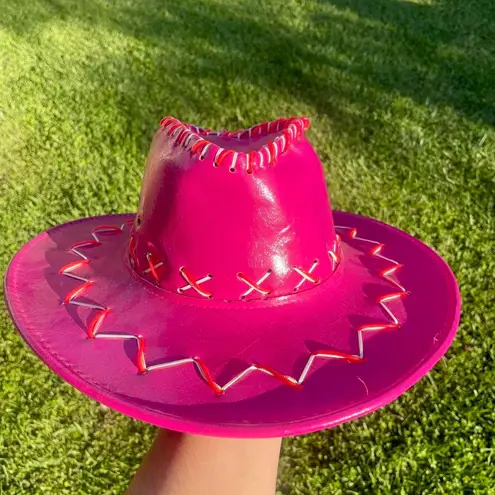 Magenta pink cowboy hat with white and red embroidered detail