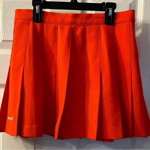 Head  orange pleated tennis skirt