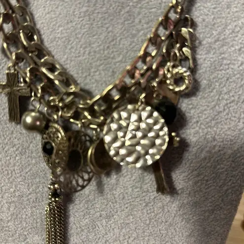 Very cute charm necklace. It has a cross with black in the middle.