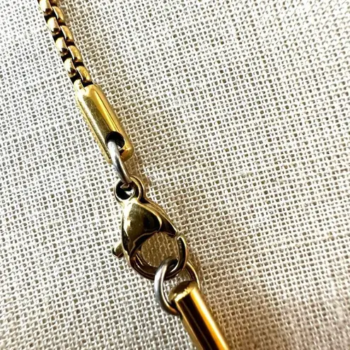 Gold tone A monogram pendant necklace