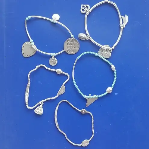 Stacked charm bracelets peace love harmony