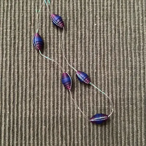 Two handmade vintage necklaces and a pair of earrings the beads are made of paper Purple