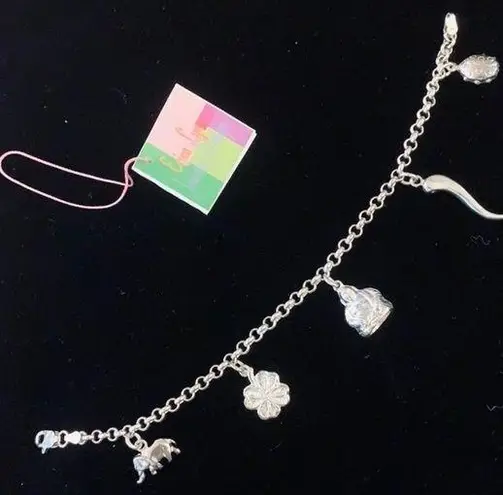 Sterling silver and peridot lucky charm bracelet.