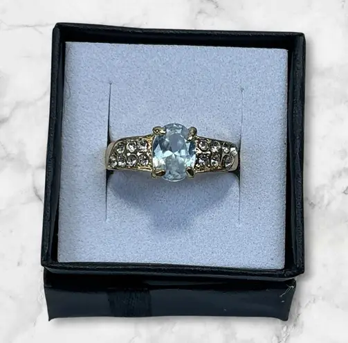 Gold Tone Ring With Oval Cut Light Blue Center Stone & Accent Crystals Size 7