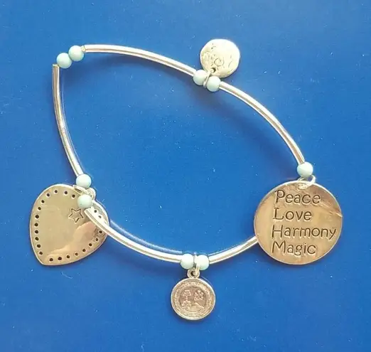 Stacked charm bracelets peace love harmony