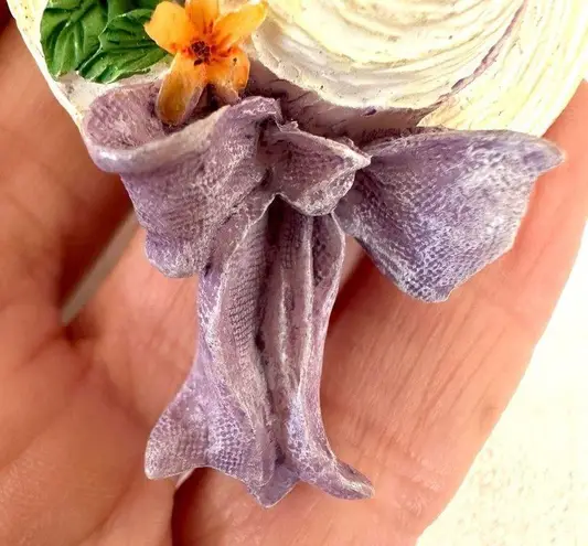 Hat with flowers and bow pin