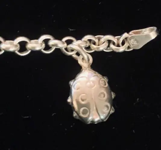 Sterling silver and peridot lucky charm bracelet.