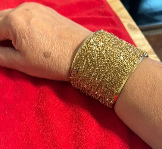 Intricate Gold Cuff Bracelet with Textured Surface and Decorative Element