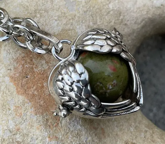 Unakite confidence gemstone in a heart shaped necklace cage. 36” chain