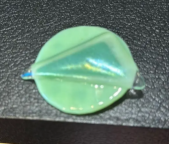 Gorgeous artisan pin. The material is glass mint round glass stone and triangle