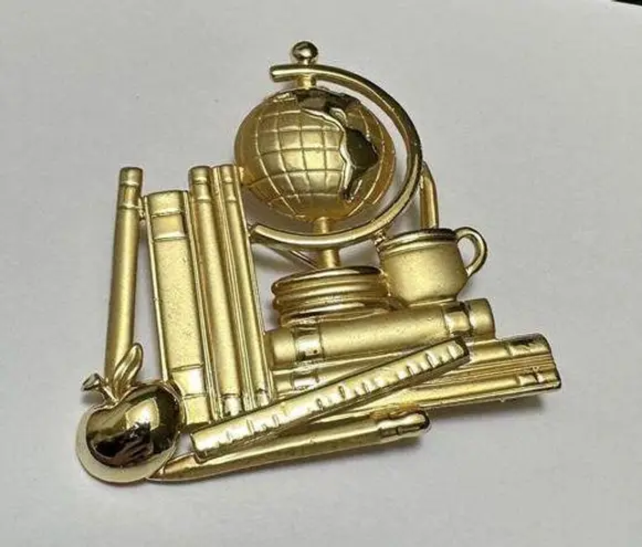 Signed AJC Gold Tone Earth Glove On A Stack Of Books Brooch Pin