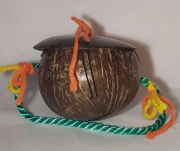 Coconut souvenir purse with painted face pearly bead nose & yarn handle Green