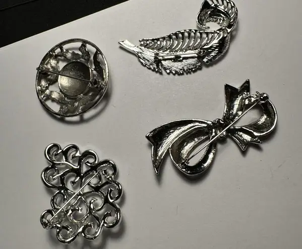 Lot Of 4 Silver Tone Brooch Pins Feather With Rhinestones, Bow, Swirls, Round