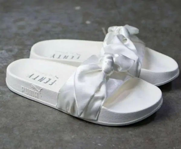 Puma bow slides black hotsell