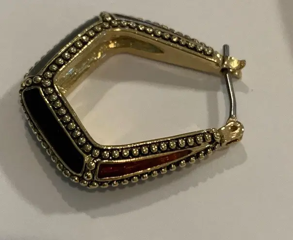 Ruby A set of 14 karat gold hoop earrings with emerald, garnet, and jewels.