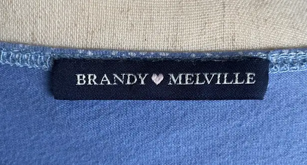 Brandy Melville Beautiful blue with tiny white flowers wrap top, long sleeves, has stretch, excellent condition, size medium Measurements: Bust: armpit to armpit 16 inches  Length: shoulder seam to bottom 17 inches