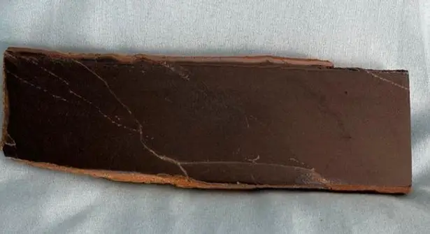 Black obsidian slab. Grayish flash running up and down. Nice piece.