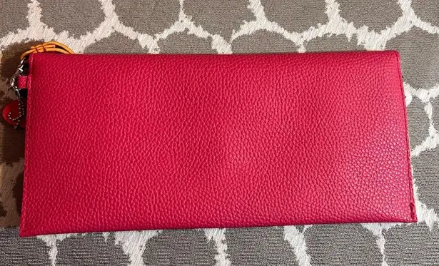 Pink Pebbled Clutch with Playful Tassel Pom Pom Trim