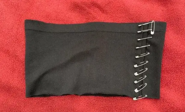 Reworked stretchy black cropped top with safety pin attachment