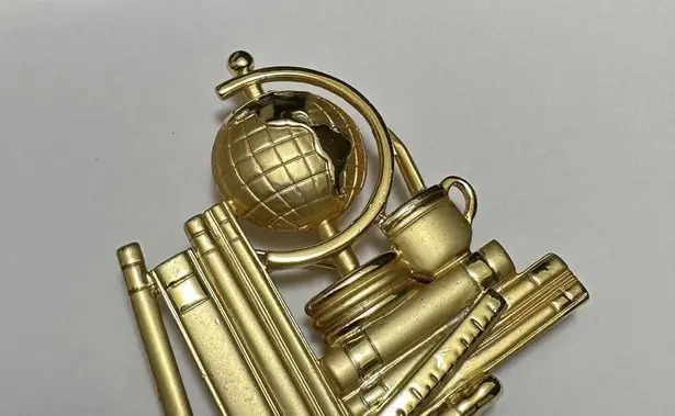 Signed AJC Gold Tone Earth Glove On A Stack Of Books Brooch Pin