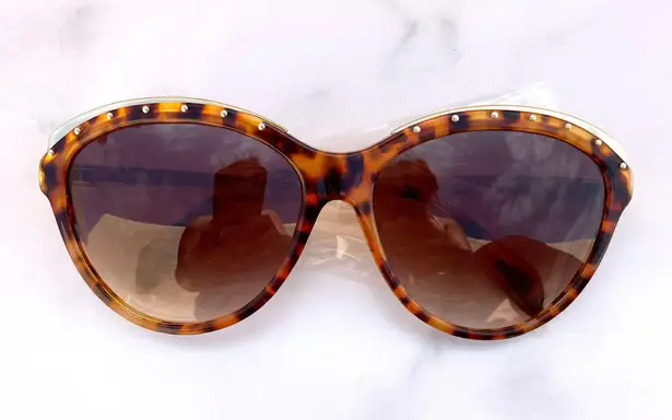 Alexander McQueen women’s AMQ 4241/S tortoise Havana gold cat-eye sunglasses