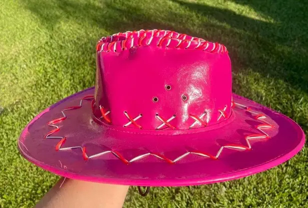 Magenta pink cowboy hat with white and red embroidered detail