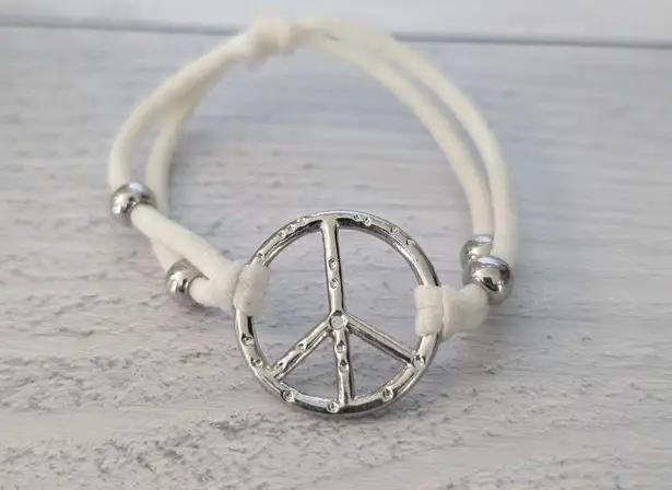 Off White Stretch Cords with Silver Tone Peace Charm Stretch Bracelet