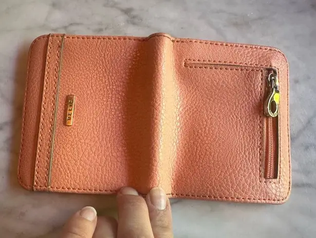 Relic pink peachy wallet paper money and coins