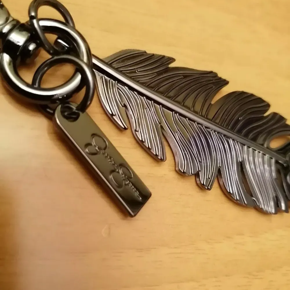 Jessica Simpson Solid Feather Pewter Color Keychain Bag Charm, Luggage Charm - Image 3