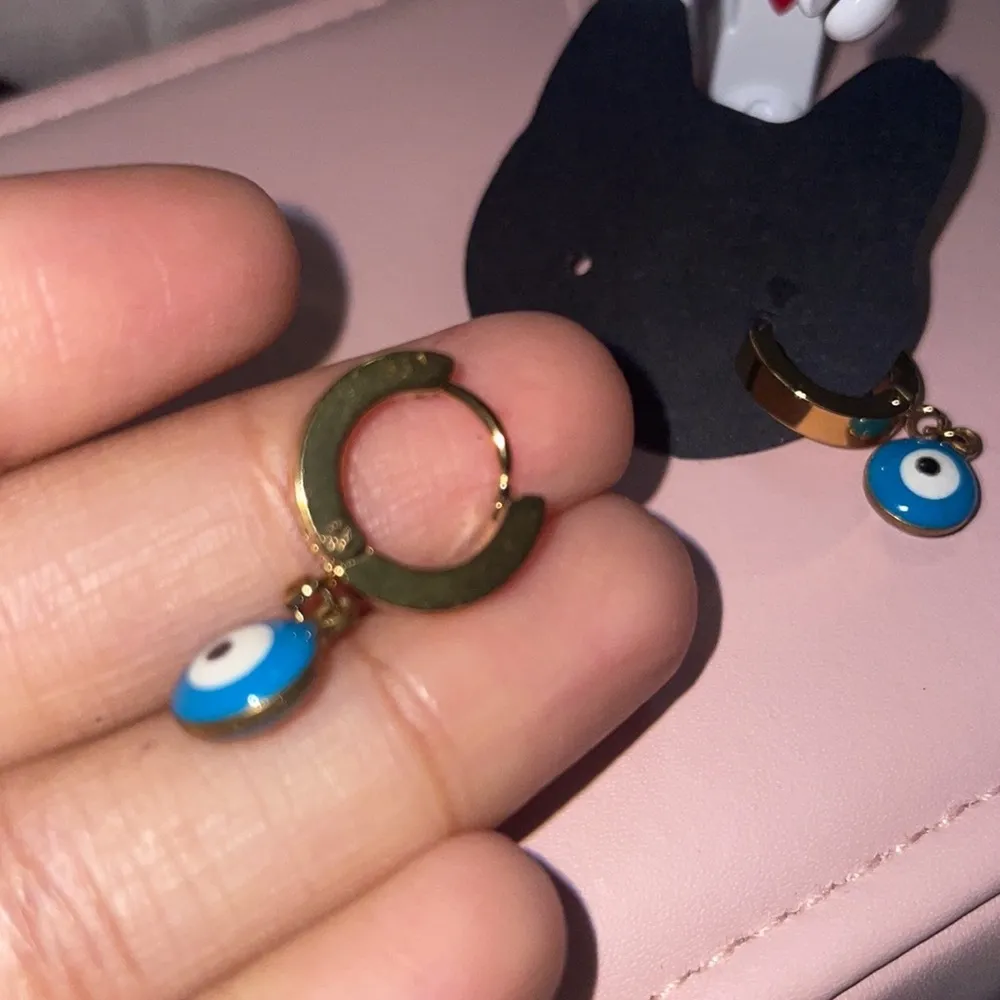 Evil eye Gold Huggies earrings - Image 7