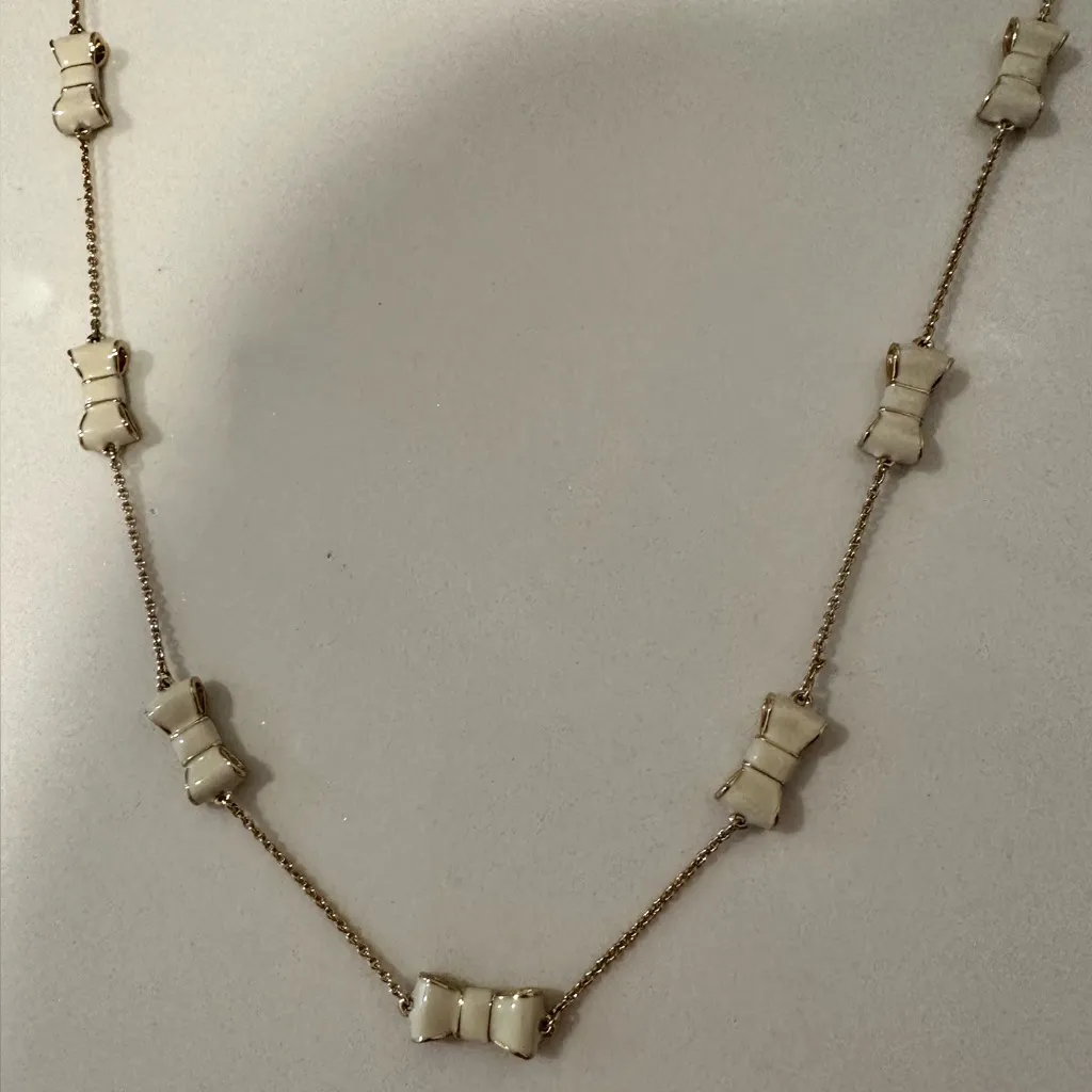 Kate Spade New York Take a Bow Gold and White Enamel Bow Scatter Chain Necklace - Image 5