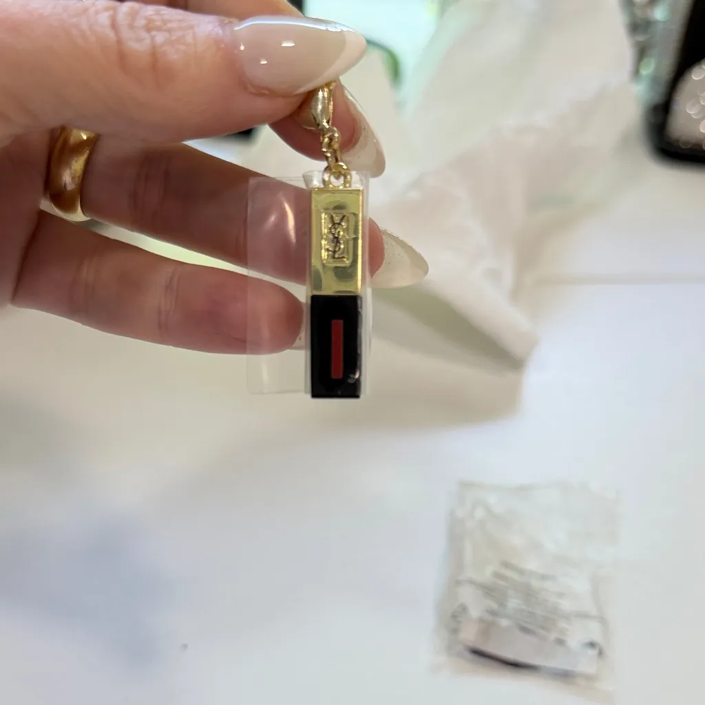 Yves Saint Laurent Gold and Black Charm with Red Detail - Image 2