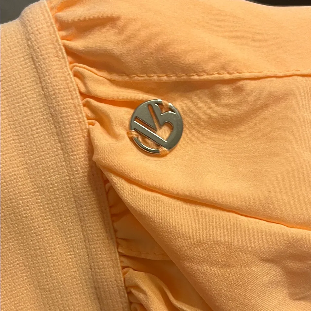 Buffbunny Court Pleated Skort in the color Peach Rings orange - Image 3