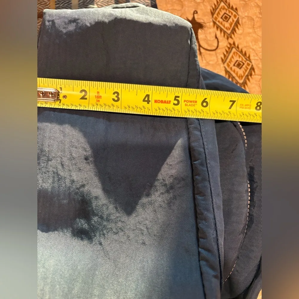 "Kaierwoke" backpack with silver zippers and a circular logo on the front Black - Image 12