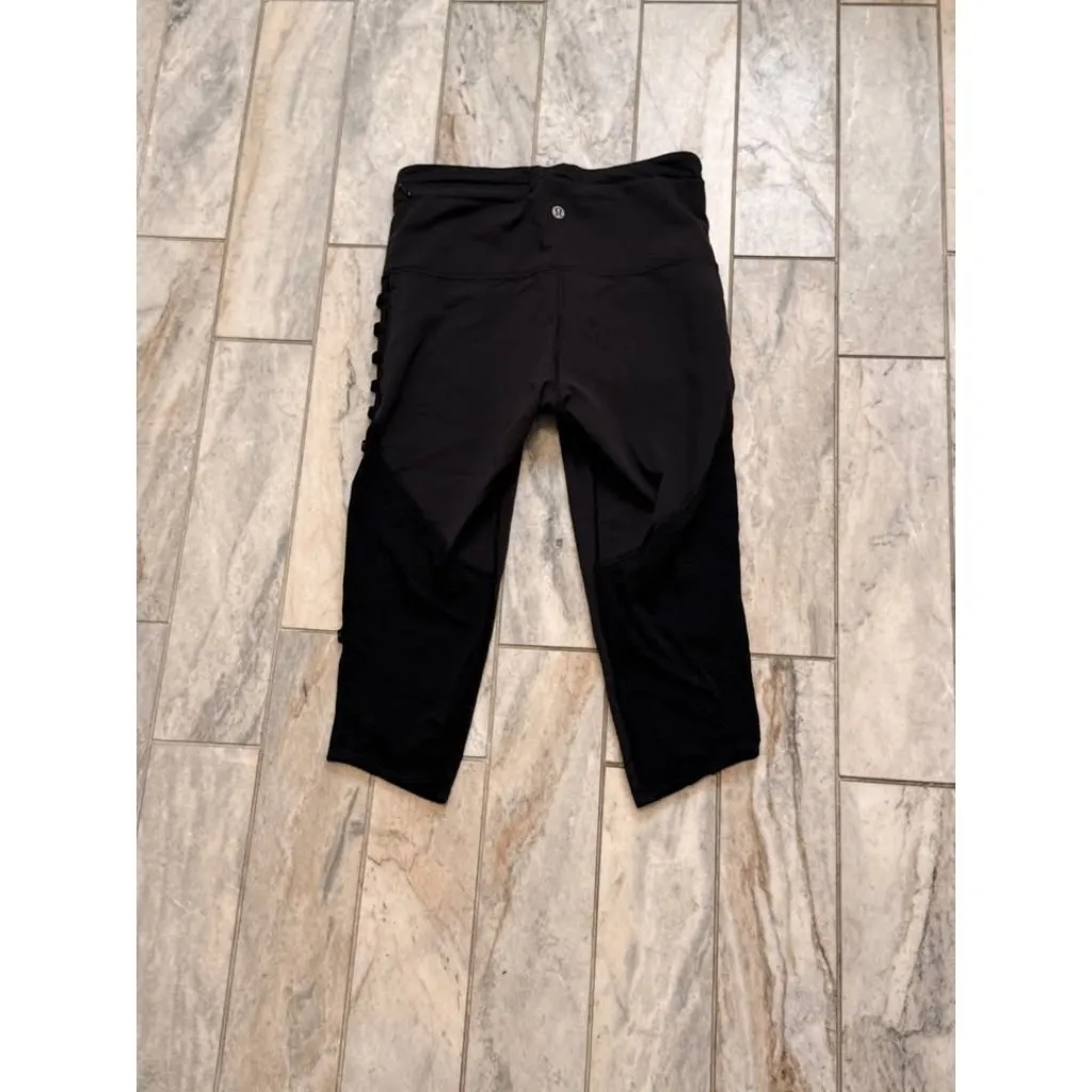 Lululemon women's size 6 black cropped leggings with reflective accents on sides - Image 3
