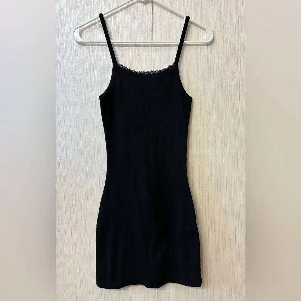 Melville Belle Lace Dress, a black ribbed cotton mini dress with a lace neckline - Image 5